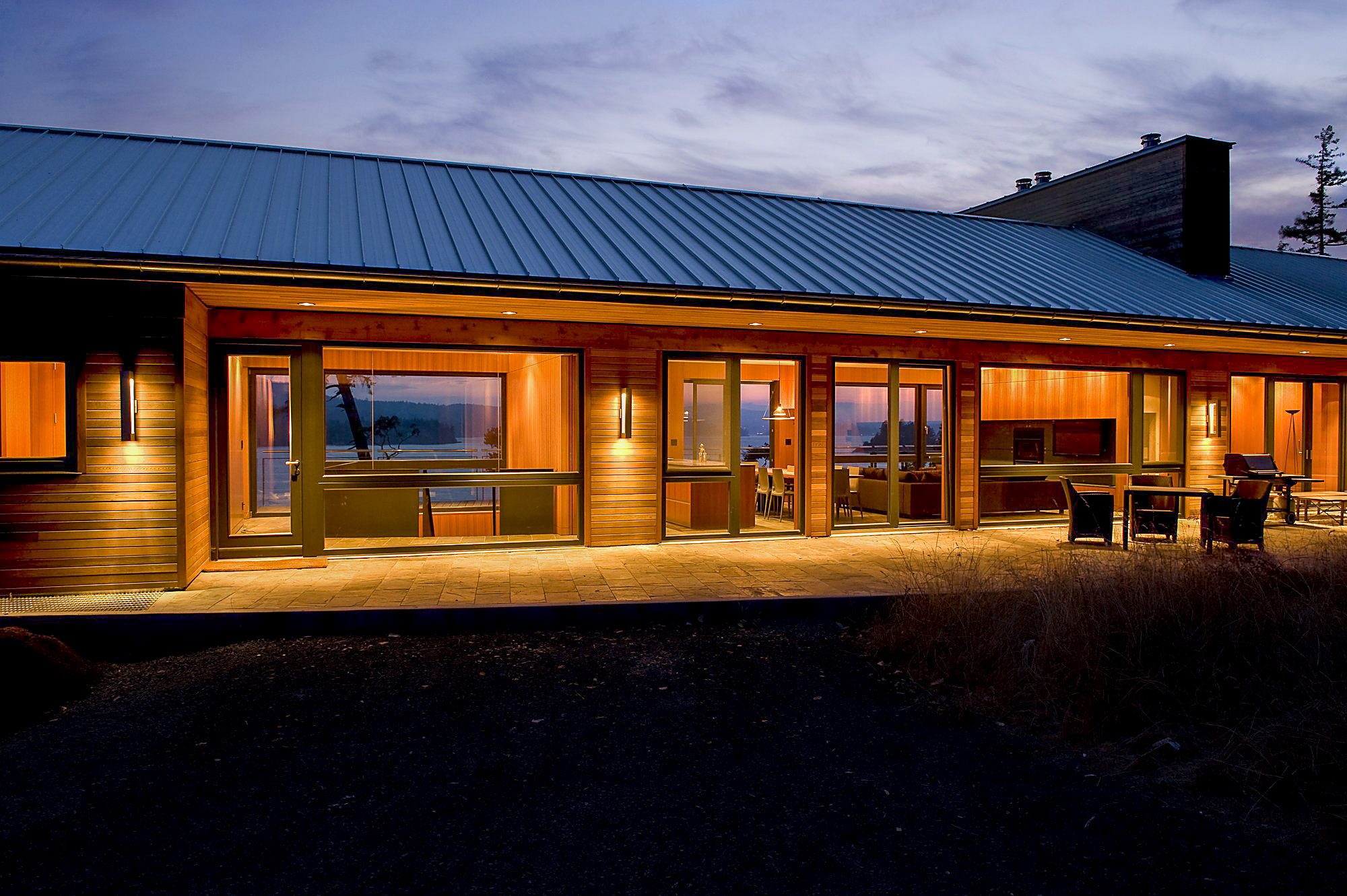 Twilight exterior of a custom cedar waterfront home built by C&W Campbell on Vancouver Island